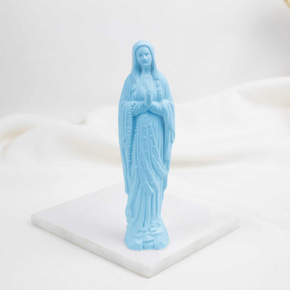 Blue Our Lady of Lourdes  statue of a religious figure on a white base
