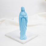 Blue Our Lady of Lourdes  statue of a religious figure on a white base