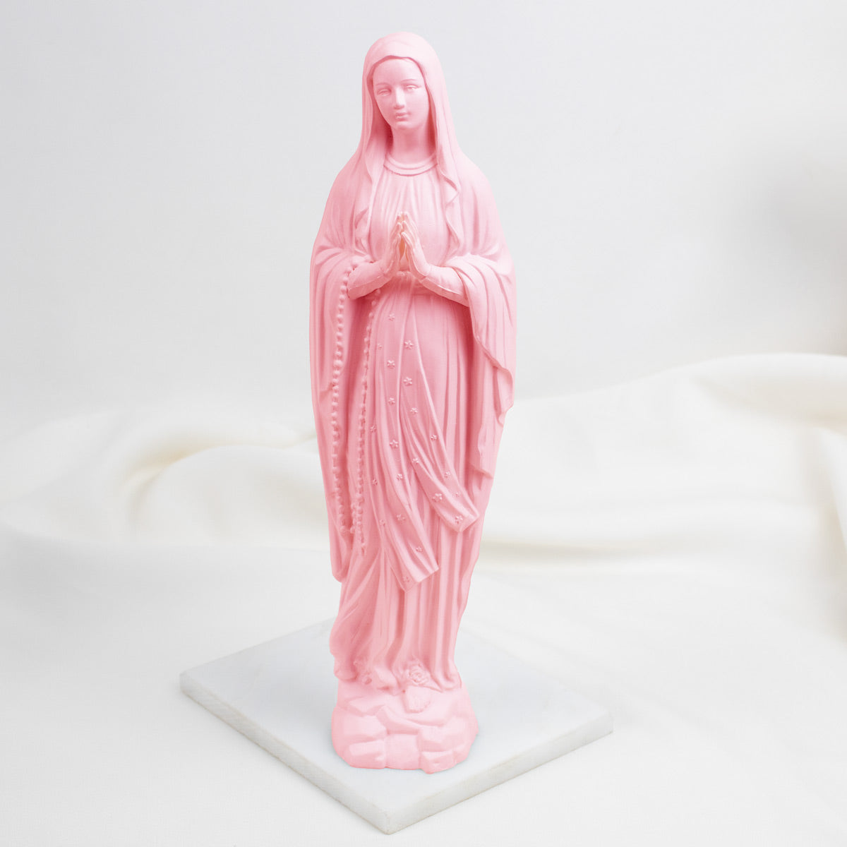 Pink Our Lady of Lourdes statue of a religious figure on a white background