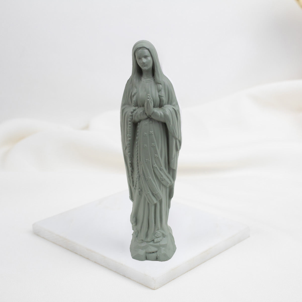 Cactus Our Lady of Lourdes  statue of a religious figure on a white base with a white background