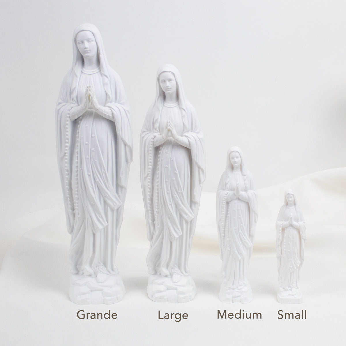 Set of four white statues labeled Grande, Large, Medium, and Small on a light gray background.