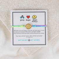 Bracelet with motivational message on a card, featuring icons and text.