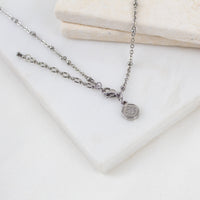 the lobster clasp, extender, and logo bug tag at teh back of the Queen of the Universe necklace