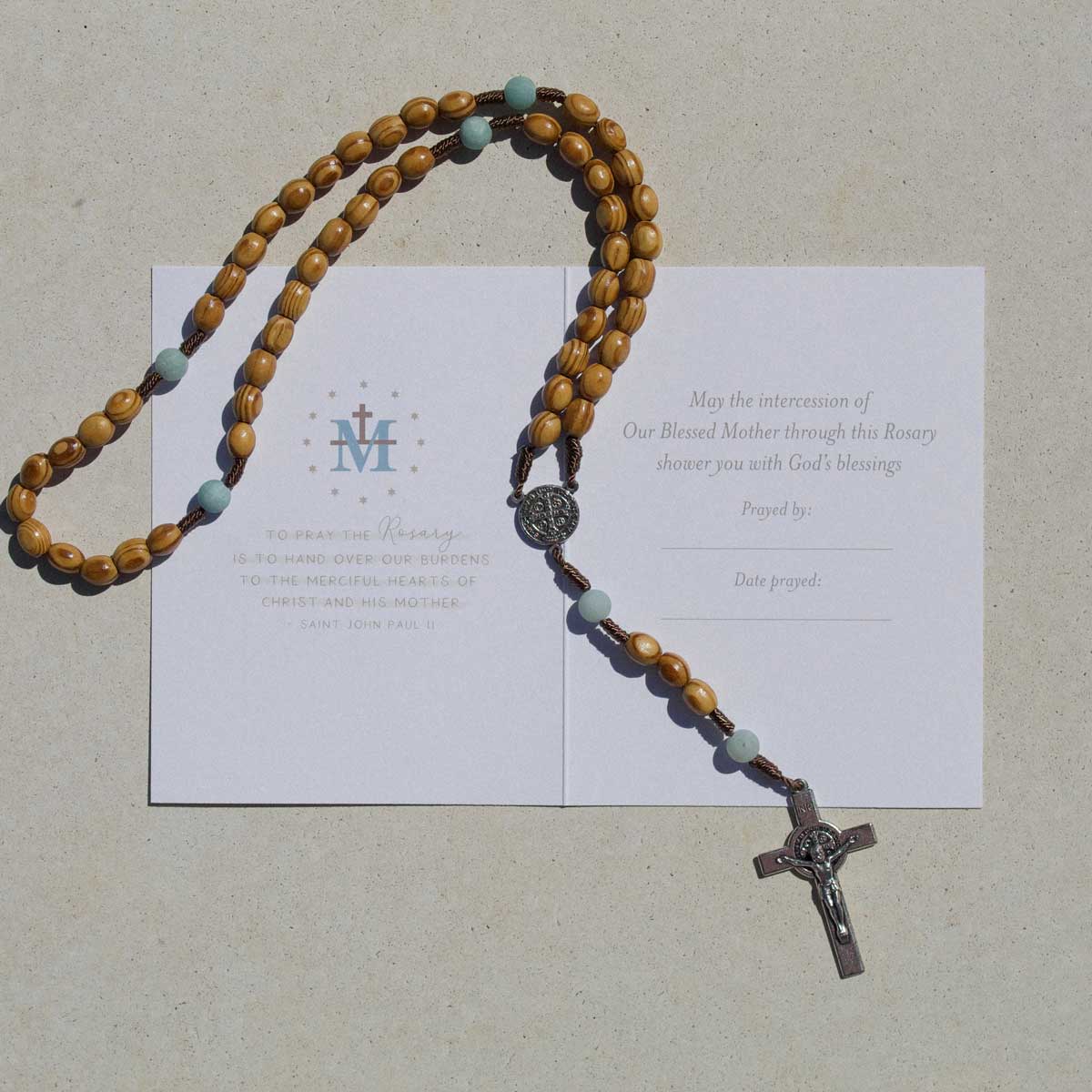 Novena gifting card with wooden and amazonite handmade rosary on top