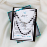 Rosary Wrap Bracelet with white, black, and gray crystals and silver tone crucifix, Miraculous Mary medal, and Benedictine medal in a gifting box