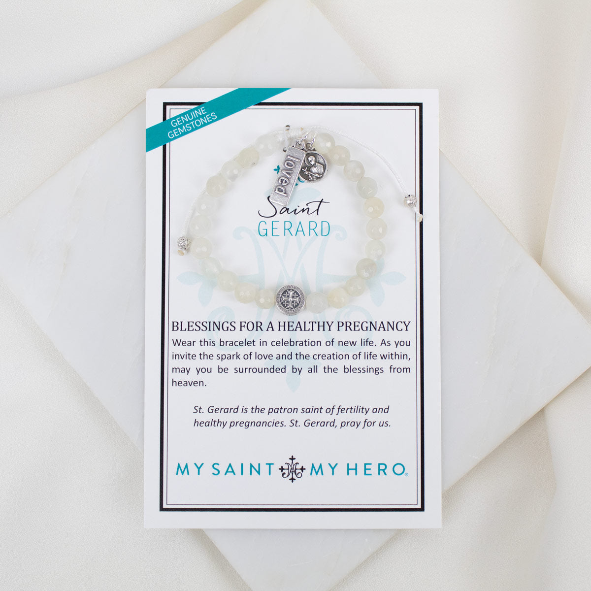 Bracelet with 'Saint Gerard' charm on a branded card with text.