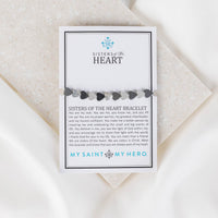Sisters of the Heart black and silver alternating heart beds bracelet on a product card