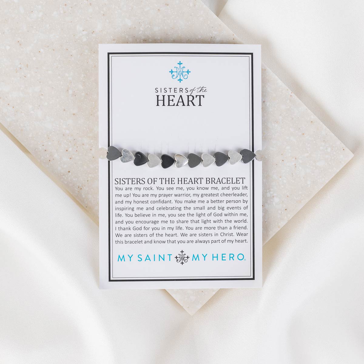 Sisters of the Heart black and silver alternating heart beds bracelet on a product card