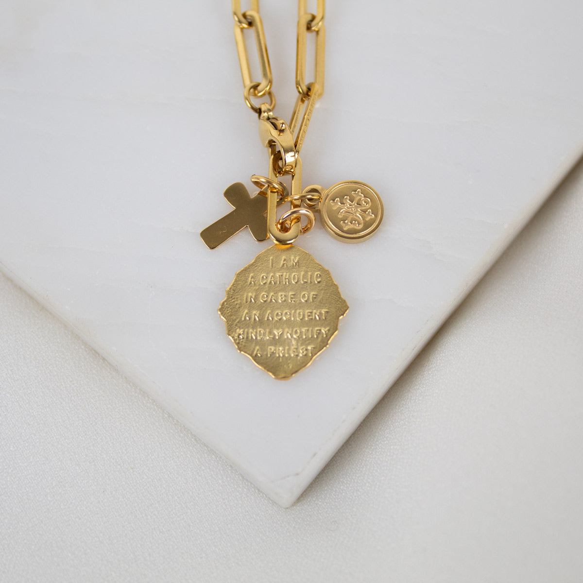 Back of the St. Christopher Medal reading, "I am Catholic in case of an accident kindly notify a priest."