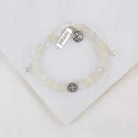 Moonstone gemstone Bracelet with  St. Gerard adn loved silver charms on a white background