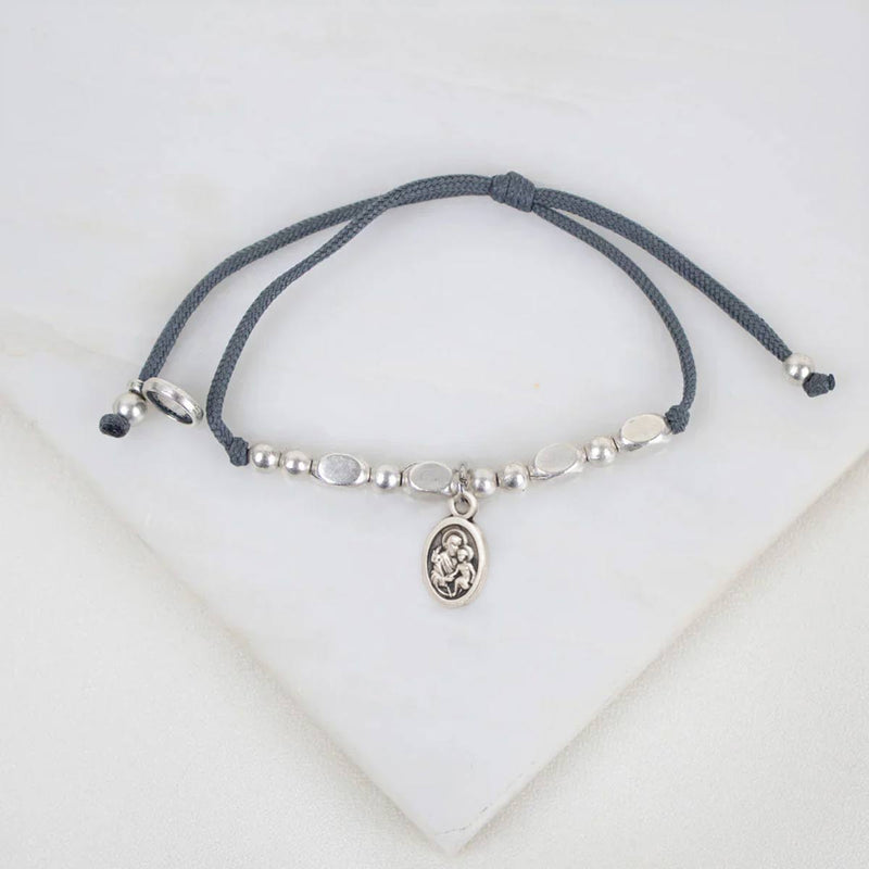 St. Joseph Bracelet beaded bracelet on a white stone background