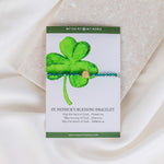 St. Patrick's Day green crystal and gold Benedictine Medal Bracelet on a St. Patrick's Shamrock gifting card