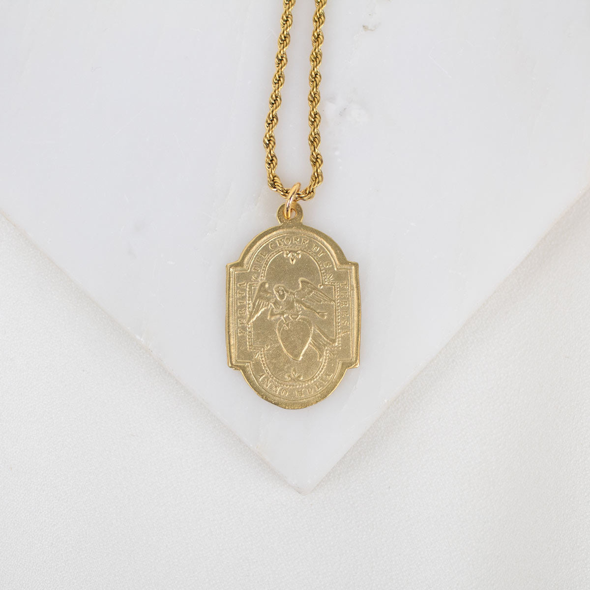 Gold necklace with a pendant on a white background