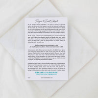 White card with printed text on a textured beige surface