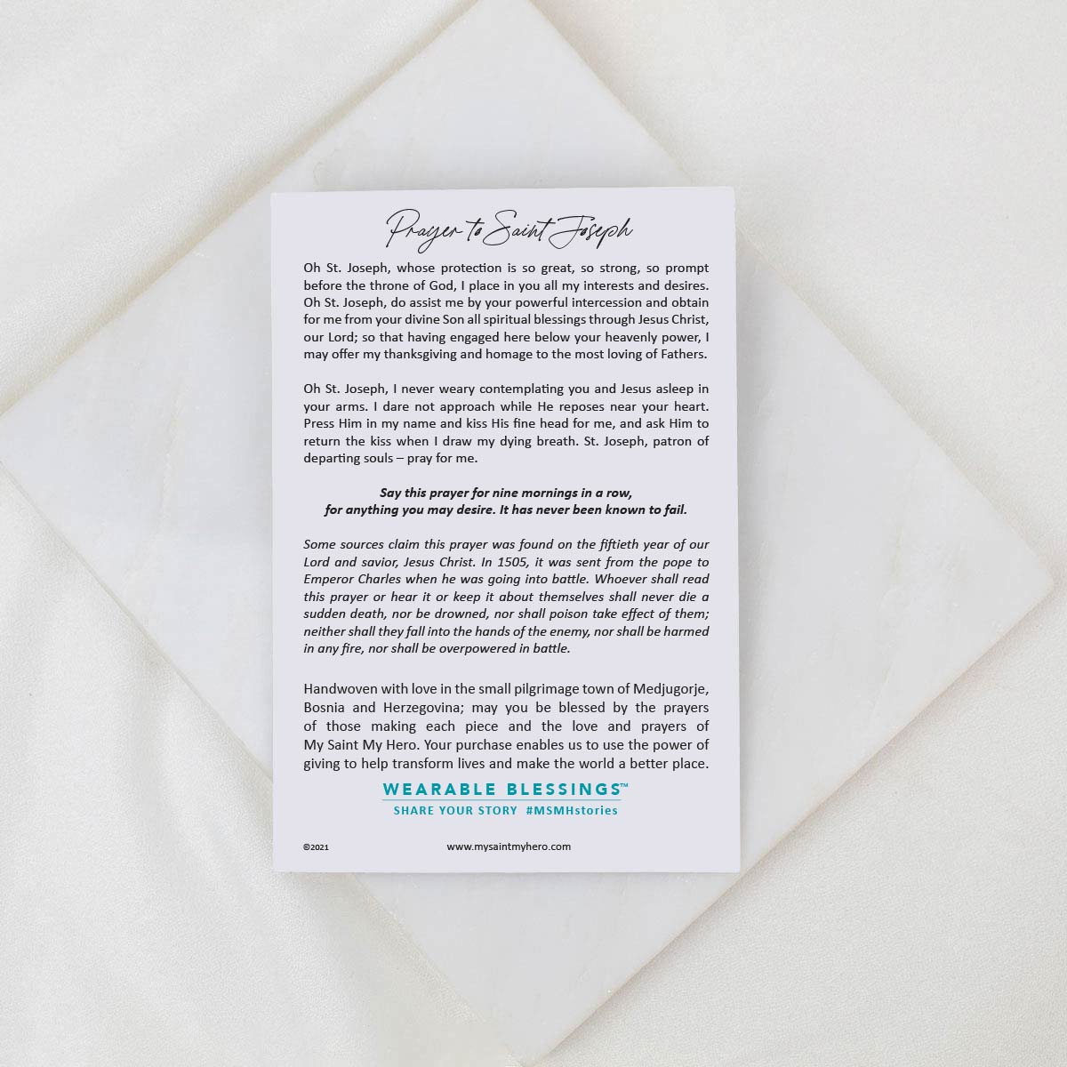White card with printed text on a textured beige surface