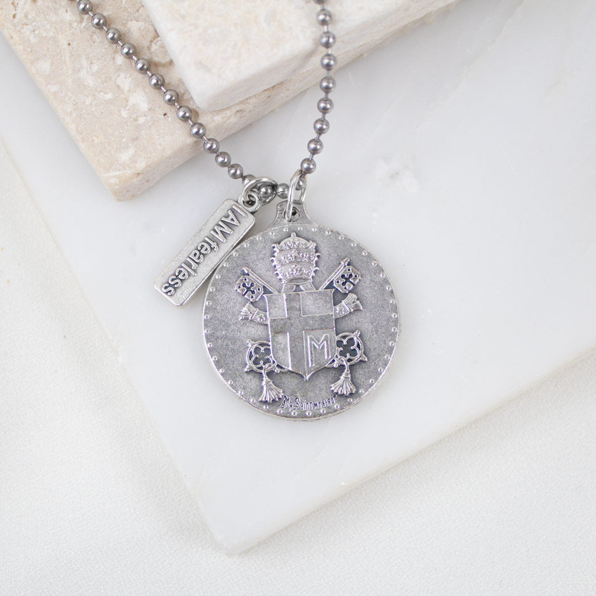 Close-up of Pope John Paul II coat of arms on the St. John Paul II Fearless Medal Necklace – exclusively designed by Vatican artist for My Saint My Hero