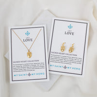 Two gold necklaces on cards with 'My Saint My Hero' branding on a white background