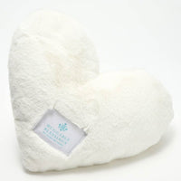 A plush, white weighted pillow in the shape of a heart with a label that reads 'Huggable Blessings'.