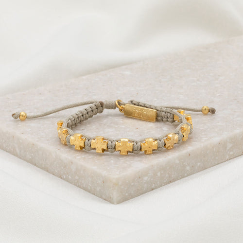 tan handwoven knotted cording slipknot bracelet with gold tone cross medals and a gold tone faith charm tag