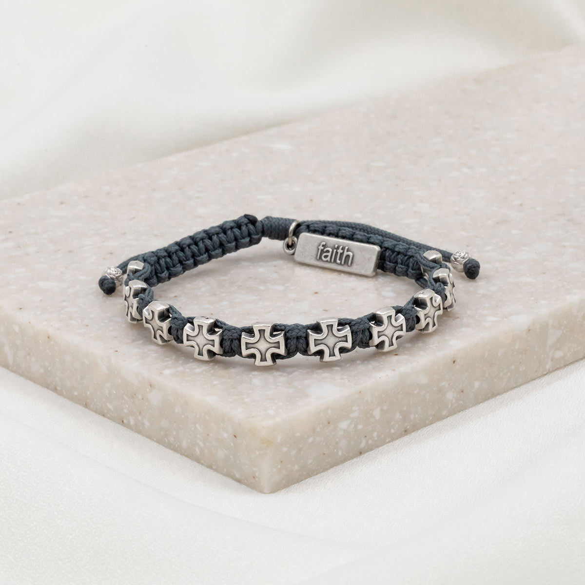 slate woven cording with ten silver tone cross medals and a faith embossed charm tag