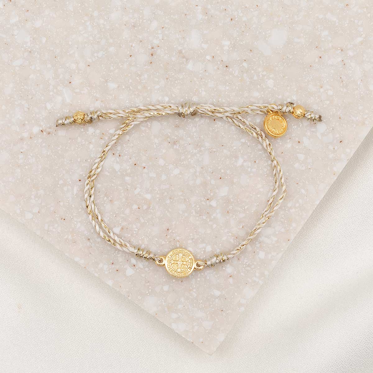 Petite St. Benedict Breath Bracelet, gold-tone medal, gold metallic bracelet cording with slipknot closure