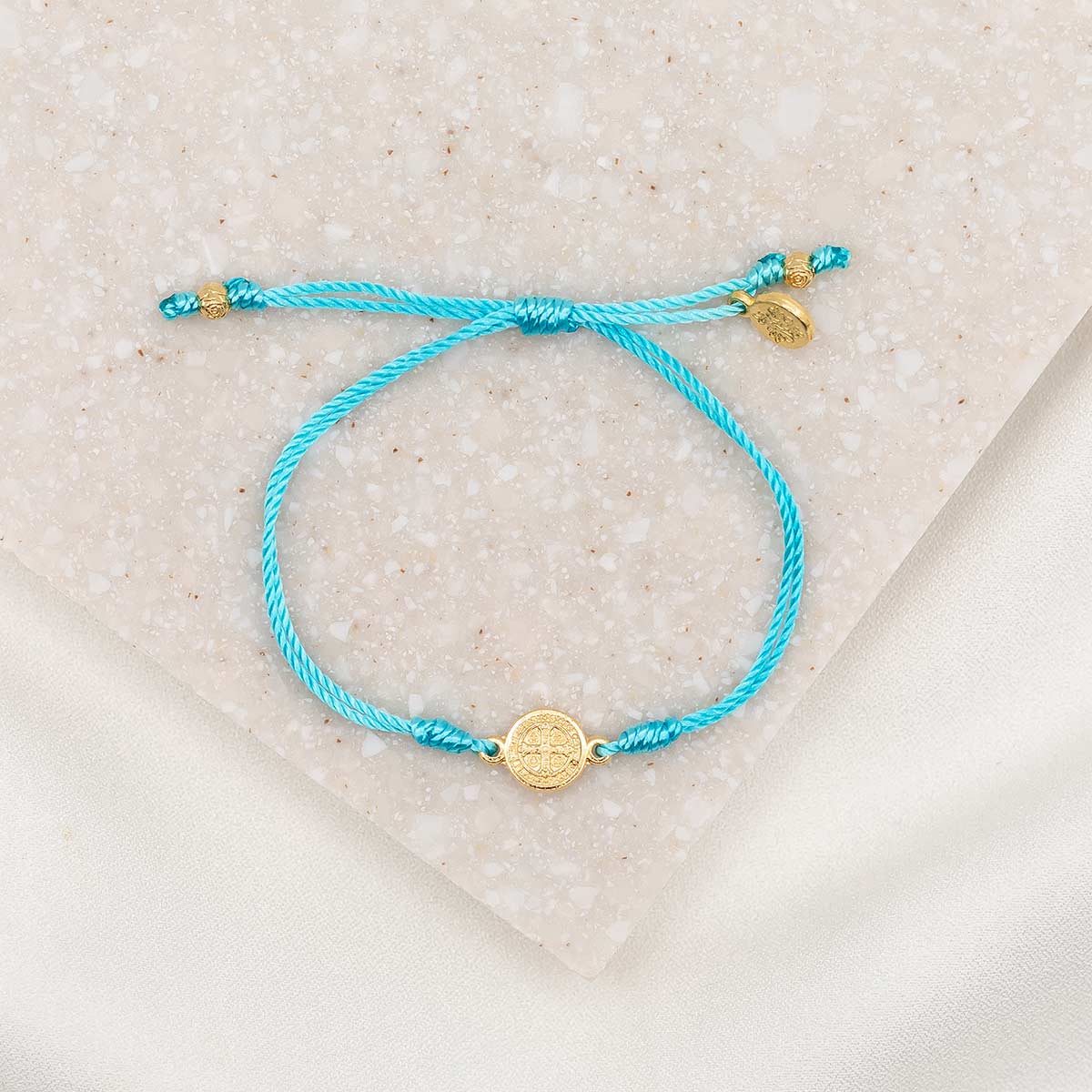 Turquoise string, gold tone St. Benedict Medal petite slipknot Breathe Bracelet