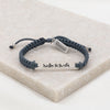 Nada te Turbe Bracelet with silver tone medals and slate cording