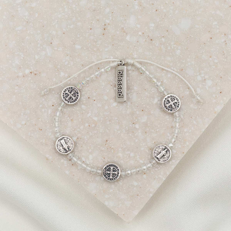 Gratitude Bracelet with clear crystal beads and five silver tone Benedictine medals and a silver tone charm tag that says "blessed"