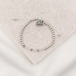 Bride Morse Code Bracelet silver with silver beads, clear and silver cyrstals and a miraculous medal on slipknot cording.