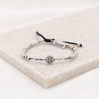 6 European crystals, silver or gold-tone beads with a silver or gold-tone Benedictine medal in the center and our signature "blessed" charm