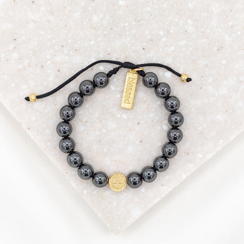 Strength Hematite Power Bracelet with a gold tone Benedictine Medal of protection on woven black cording