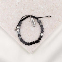 hematite heart bracelet with silver loved charm and my saint my hero bead