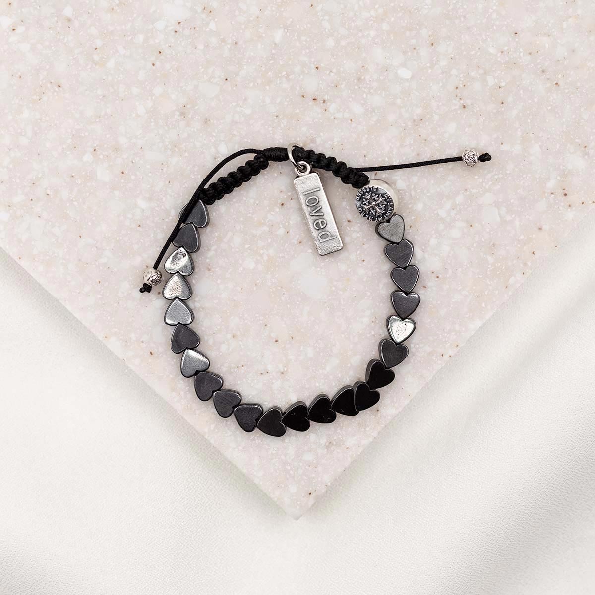 hematite heart bracelet with silver loved charm and my saint my hero bead