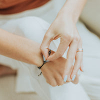 close up of using the St Ignatius of Loyola Spiritual Awareness Bracelet for spiritual awareness prayers