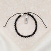 Black onyx gemstone and silver tone cross slipknot bracelet with silver tone faith tag charm