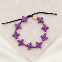 Grounded in Faith Howlite  Cross Bracelet purple dyed gemstones gold medal and beads