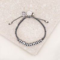 slate silver overhead shot of My Saint My Hero Little Words Project Blessed Bracelet