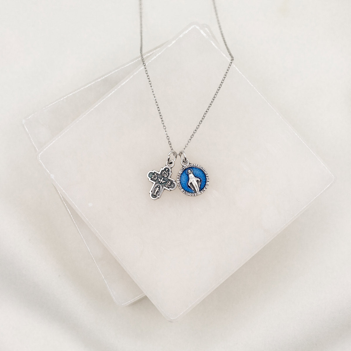 Vintage Blessing Lineage of Love Necklace with a silver tone four way and a blue enamel Miraculous Medal on a silver tone chain 