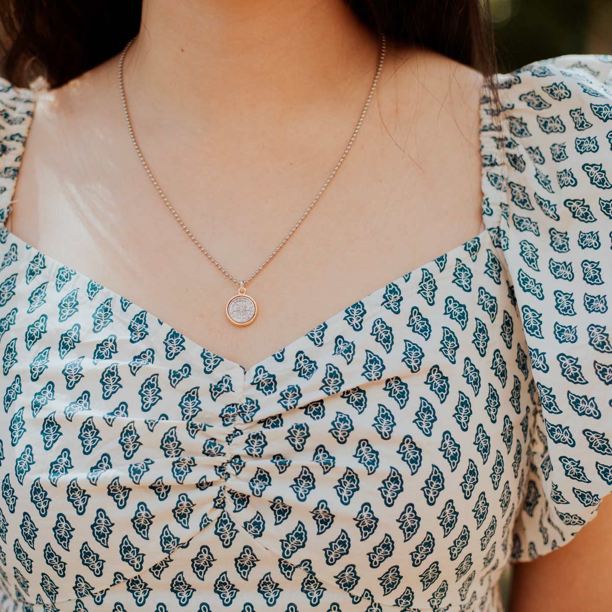 woman wearing the 18" small Benedictine Gold Medal Necklace