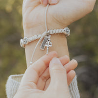 Crucifix Medal on a woven bracelet