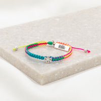 rainbow cording woven slip knot bracelet with silver tone medal and silver tone faith tag