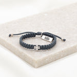 slate cording woven slip knot bracelet with silver tone medal and silver tone faith tag