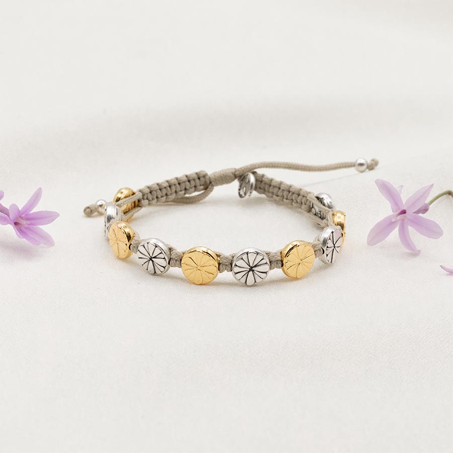 Tan cording, slipknot closure, gold and silver tone floral medals