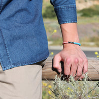 close up of young man's wrist wearing Protect & Serve in Gratitude Bracelet