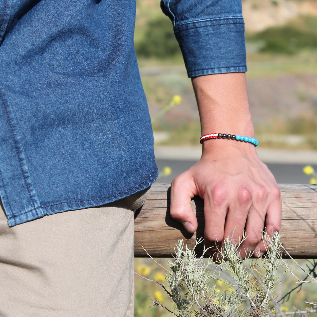 close up of young man's wrist wearing Protect & Serve in Gratitude Bracelet