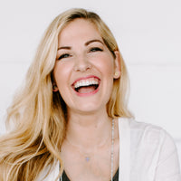 Woman laughing wearing gold tone Benedictine Stud Earrings