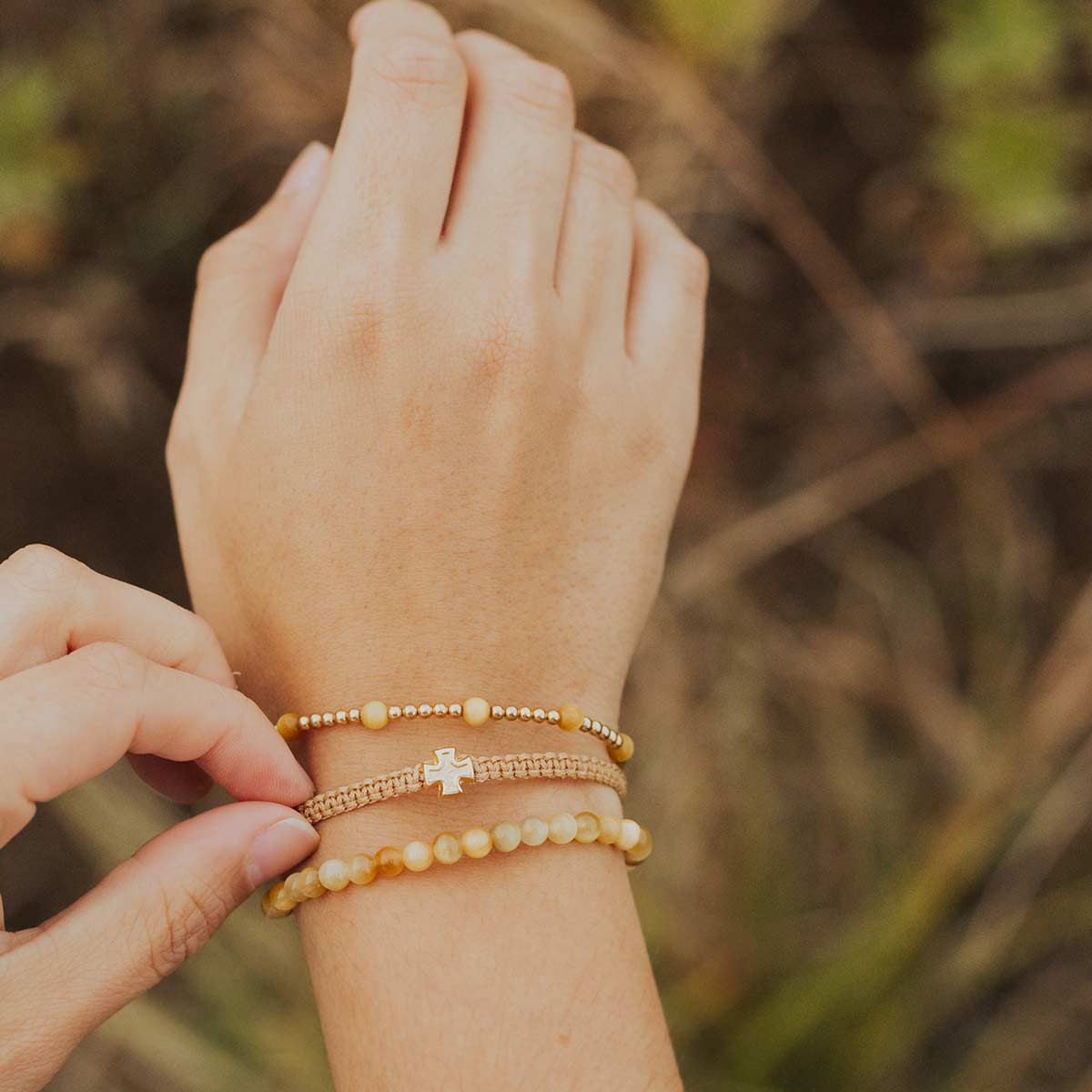 close up of wrist wearing a Be Still Three Bracelets Woven into One Bracelet