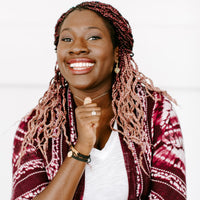 Young woman wearing a Petite Necklace and Blessing Bracelets