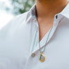 Close up of man in button down shirt wearing a Benedictine Two Tone Bead ball Necklace