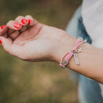 women's hand wearing blessing for a cure benedictine blessing bracelet